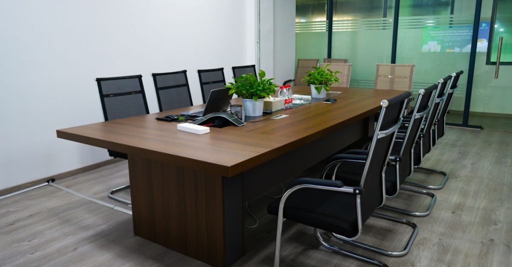 Phòng họp chuyên nghiệp có bàn dài, ghế hiện đại và cây xanh.